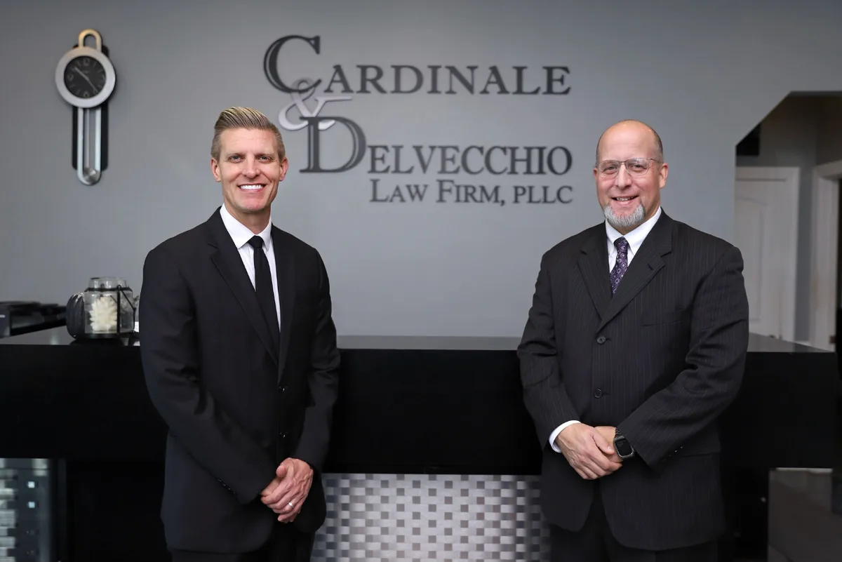 Partners Michael R. Cardinale and John A. DelVecchio at the front desk of the Cicero office